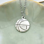 Laser Engraved Basketball charm pendant in silver tone metal on a stainless steel satellite chain. Girl's necklace. Basketball player gift.